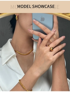 Detailed view of twisted gold-plated titanium steel necklace and bracelet set on a model