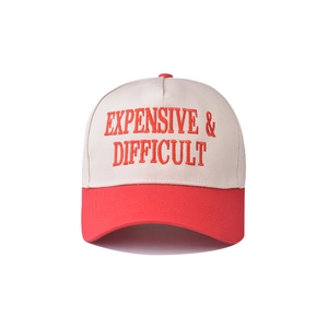 Close-up of red 3D embroidery on a two-tone cotton baseball cap with white crown