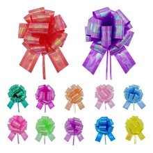 Close-up of assorted colorful metallic gift bows with iridescent finish in various sizes