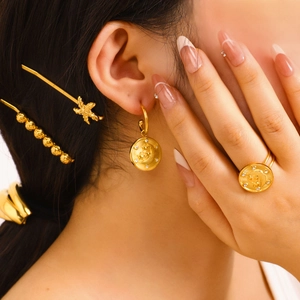 Vintage celestial gold jewelry set with star and moon charms and sparkling rhinestones
