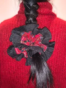 Close-up of a double-layered oversized plaid scrunchie with black pleated lace detail