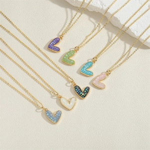 Golden heart pendant necklaces set in seven vibrant colors with shimmering shell texture