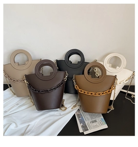 Collection of leather bucket bags with round handles and chunky chain details in five colors