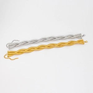 Detail of 18K gold and silver triple-braided snake chain with lobster clasp and extender