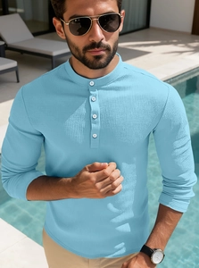 Detail of light blue waffle knit fabric and four-button placket on men's polo shirt