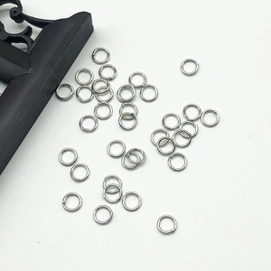 Macro view of silver jump rings for DIY jewelry making on a clean white background
