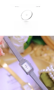 Macro view of rectangular silver watch with mineral glass mirror and roman numerals