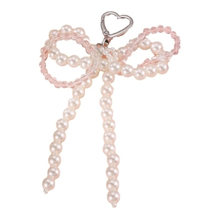 Pink heart-shaped bow keychain with faux pearls and transparent beads on white background