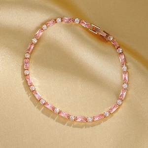 Detail of rose gold tennis bracelet with pink rectangular and white round zircons