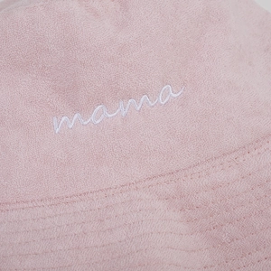 Close-up of pink terry cloth bucket hat with mama embroidery and stitching detail