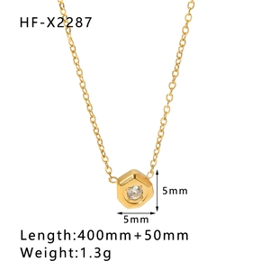 Detailed macro view of a 14k gold-plated hexagon pendant with a zircon stone on a chain