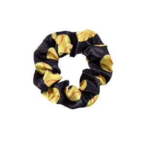 Satin scrunchie with yellow softball and red stitching pattern on white background