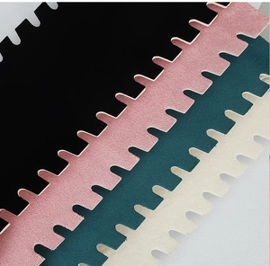 Detail of plush foam floor mats in black, pink, and green showing the soft velvet texture