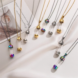 Detailed view of refillable glass perfume bottle necklaces in gold and silver finishes