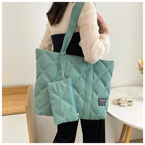 Detailed view of mint green quilted tote bag with matching zipper coin pouch