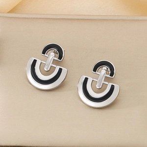 Detailed close-up of U-shaped stainless steel earrings with black enamel inlay finish