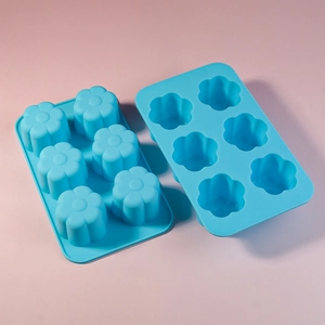 Macro detail of flexible blue silicone 6-cavity flower molds for baking and DIY crafts