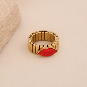 Detail view of elastic gold-tone ring with a 3D red lip element and metallic segments