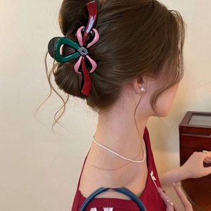 Pince à cheveux nœud rétro multicolore pour coiffure longue portée par un modèle