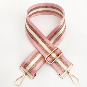 Close-up of pink and gold striped woven strap with polished metal lobster clasps