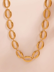 Close-up of polished gold-tone oval link chain necklace with high gloss metal finish