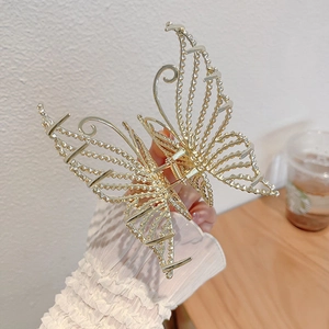 Elegant gold butterfly hair claw clip with rhinestones and hollow metal textures for women