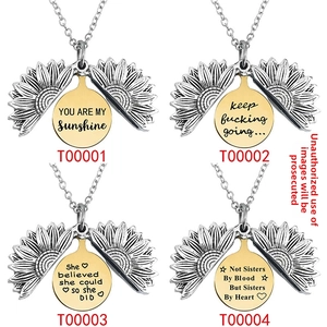 Detail of four sunflower necklaces with different engraved quotes inside on a white background