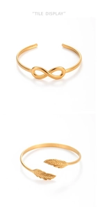 Detailed view of gold leaf and infinity symbols on adjustable stainless steel bracelets