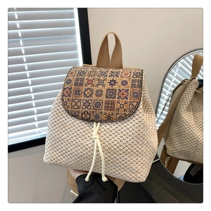 Detail of woven straw backpack with ethnic print flap and drawstring closure