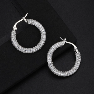 Macro shot of high-quality silver hoop earrings with sparkling white cubic zirconia stones