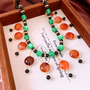 Vintage style bohemian multi-color beaded necklace with colorful glass beads and gold accents
