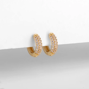Macro shot of 18K gold hoop earrings featuring multi-row micro-pave white zircon stones