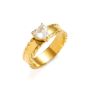 Detailed view of golden heart zircon ring with textured satin finish wide band
