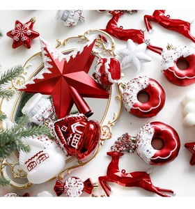 Flat lay of red and white Christmas ornaments including stars, donuts and reindeers