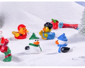 Miniature resin hockey ducks and snowmen figurines set in winter Christmas scene