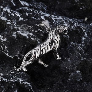 Polished viking tiger pendant necklace for men on volcanic rock background