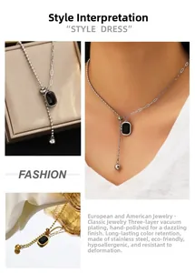 Macro view of gold stainless steel Y-necklace with black rectangular gemstone charm