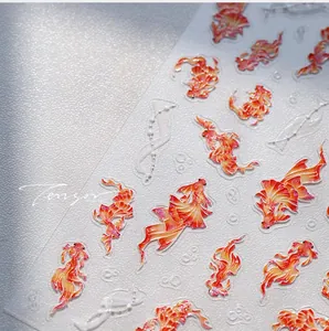 Detailed macro view of 3D embossed koi fish nail stickers with gold stamping