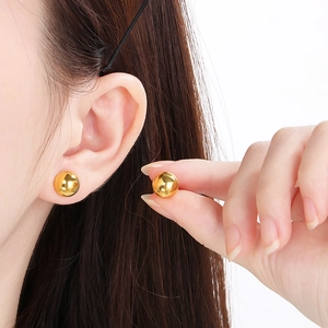 Classic minimalist golden half-ball stainless steel stud earrings for women on model