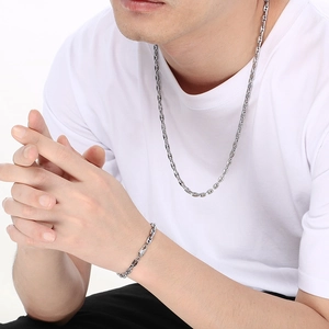 Polished stainless steel pig nose chain necklace and bracelet set worn by a model