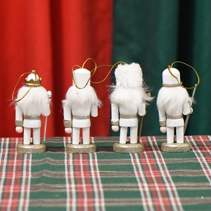 Set of 4 white and gold 10cm wooden nutcracker ornaments with glitter for Christmas trees