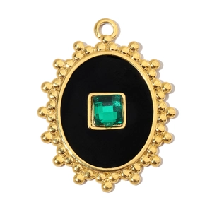 Detailed macro view of vintage oval pendant with emerald stone and golden beaded frame