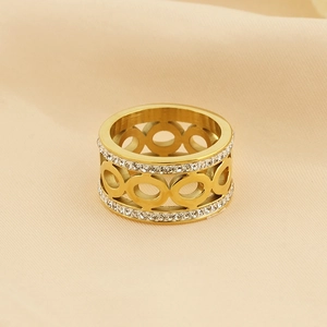Golden cutout hollow circle ring with pavé rhinestones on beige fabric background