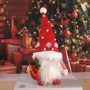 Christmas gnome doll with red hat and gift bag on festive background scene