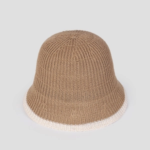 Detailed view of the khaki and white patchwork knitted texture on this elegant bucket hat