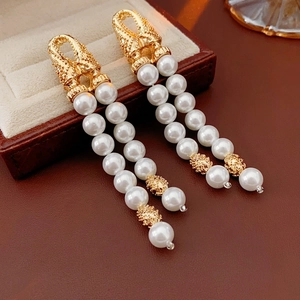Vintage gold pearl tassel drop earrings with double strands and geometric metal textures