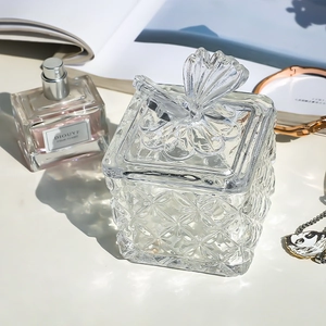 Elegant clear glass jewelry storage jar with embossed diamond texture and butterfly lid handle