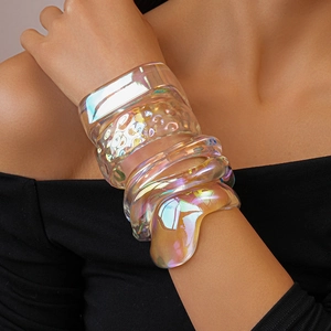 Close-up of set of iridescent acrylic wide bangles with wave and hammered textures