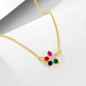 Macro view of floral pendant necklace with colorful cubic zirconia and gold finish