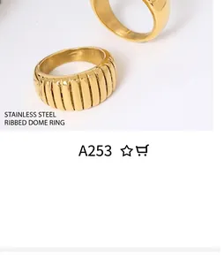 Macro detail of gold-plated twisted croissant ring with a polished ribbed texture
